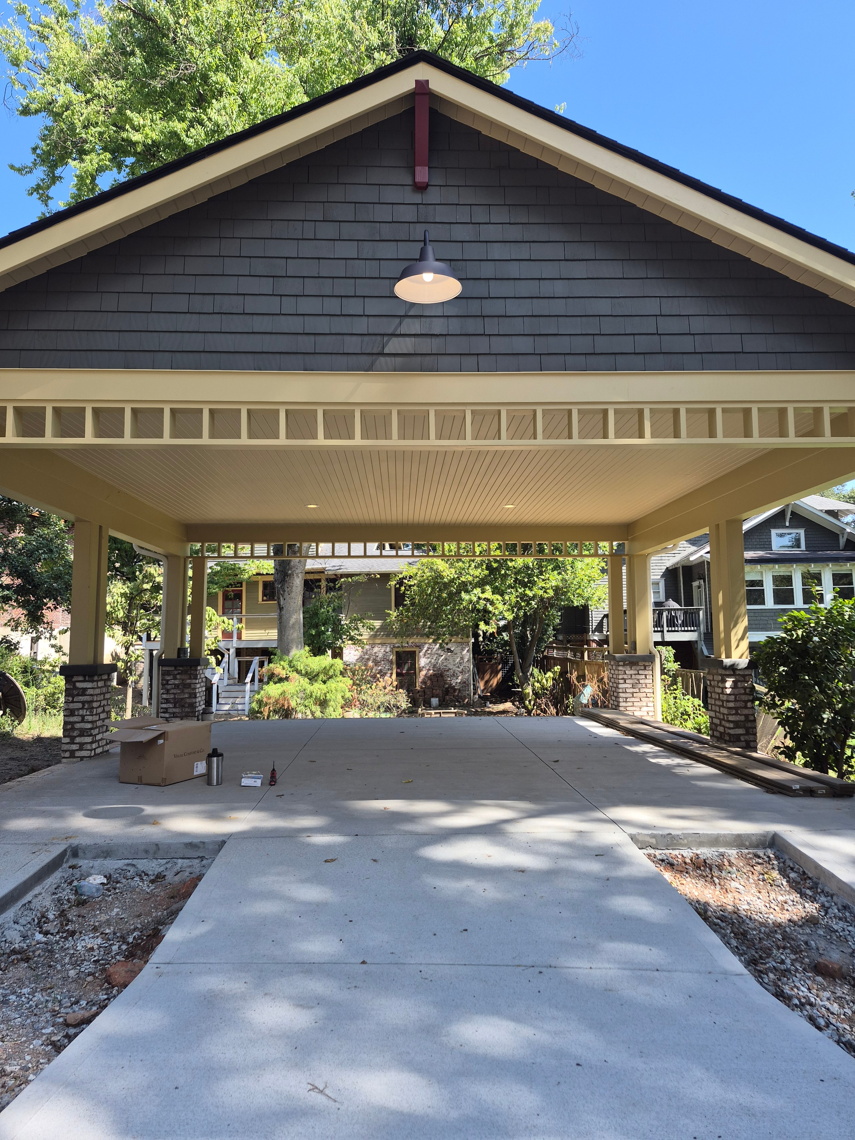 Exterior barn-style wall light installation on residential gable