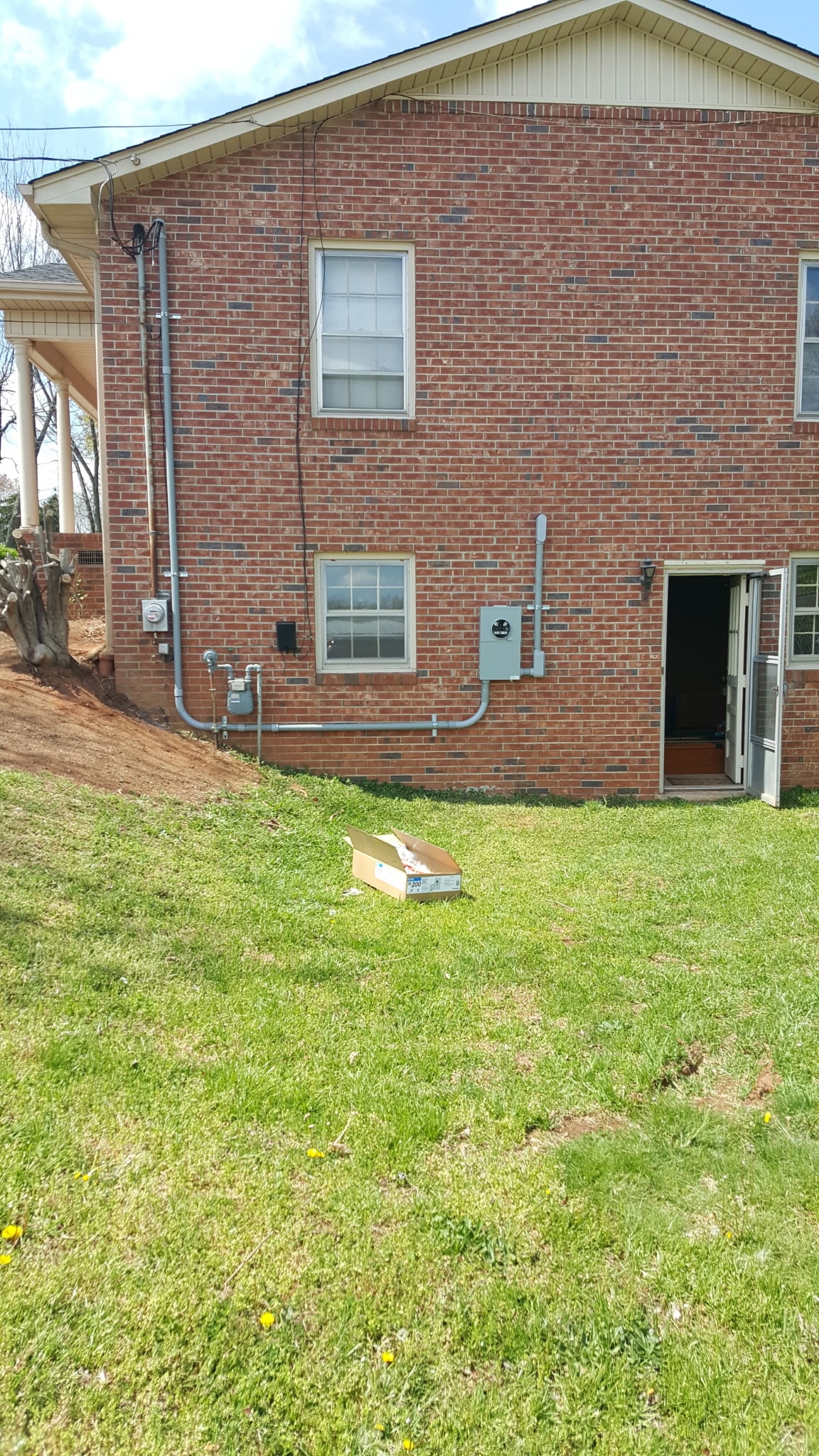 Residential electrical service upgrade on brick home exterior